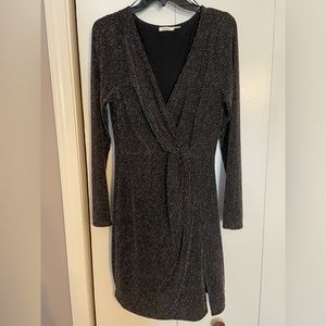 Long sleeve black mini dress. Stretchy material with a feaux wrap.